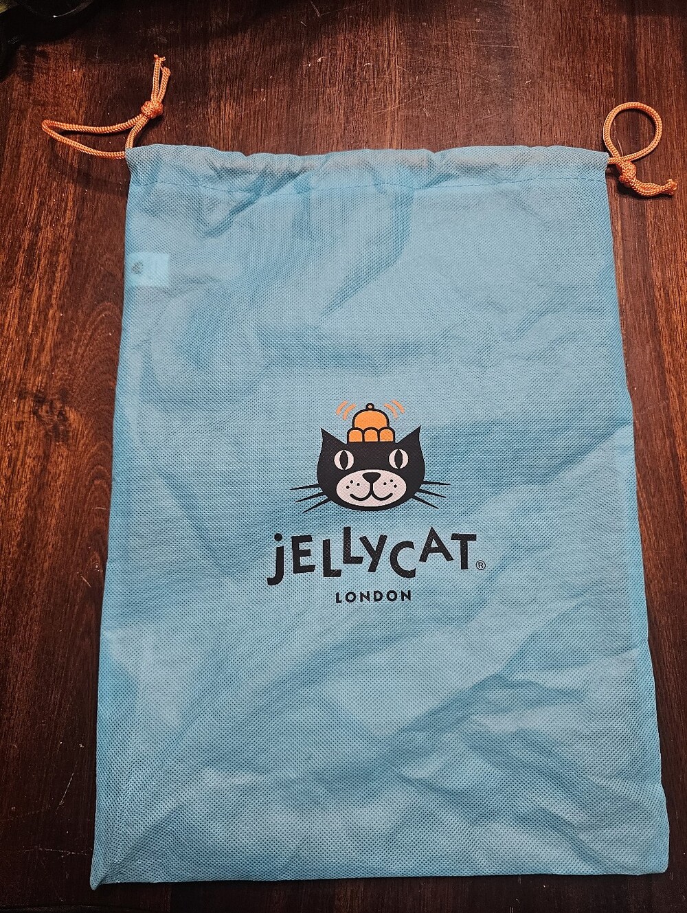Jellycat turquoise drawstring cat storage bag with orange cord